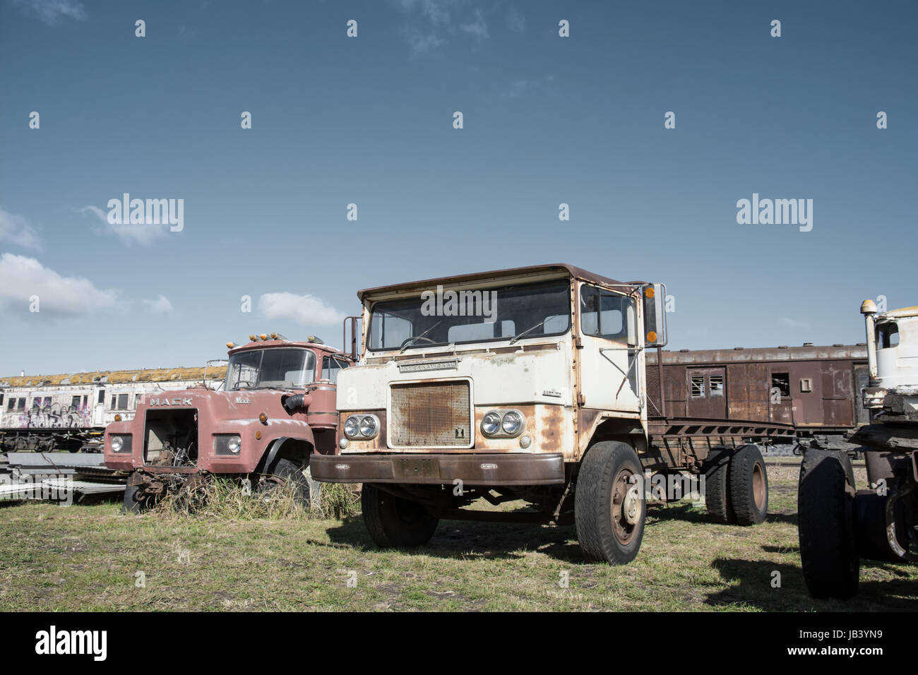 Two Derelict Trucks in a Vehicle Graveyard. Stock Photo
