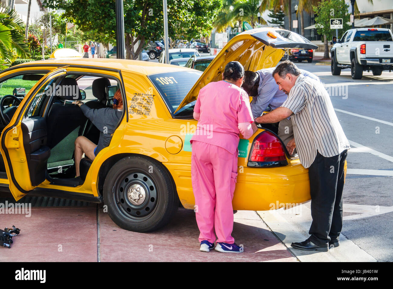Miami Beach Florida,driveway,yellow cab,taxi,trunk,unloading,adult adults  man men male,woman women female lady,passenger passengers rider  riders,drive Stock Photo - Alamy
