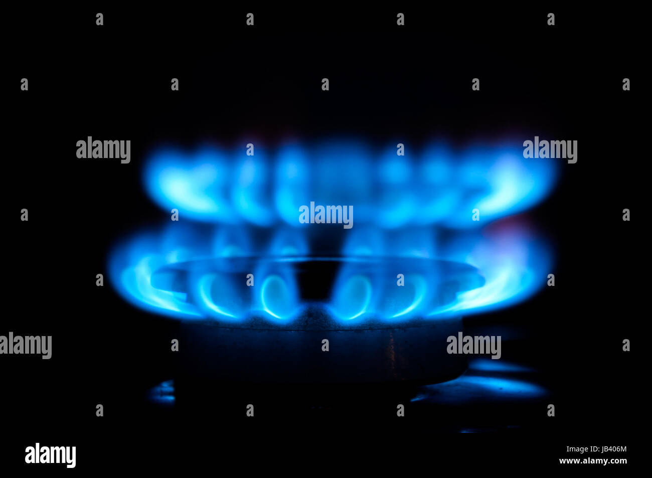 Blue gas flames from two stove burners in the dark Stock Photo Alamy
