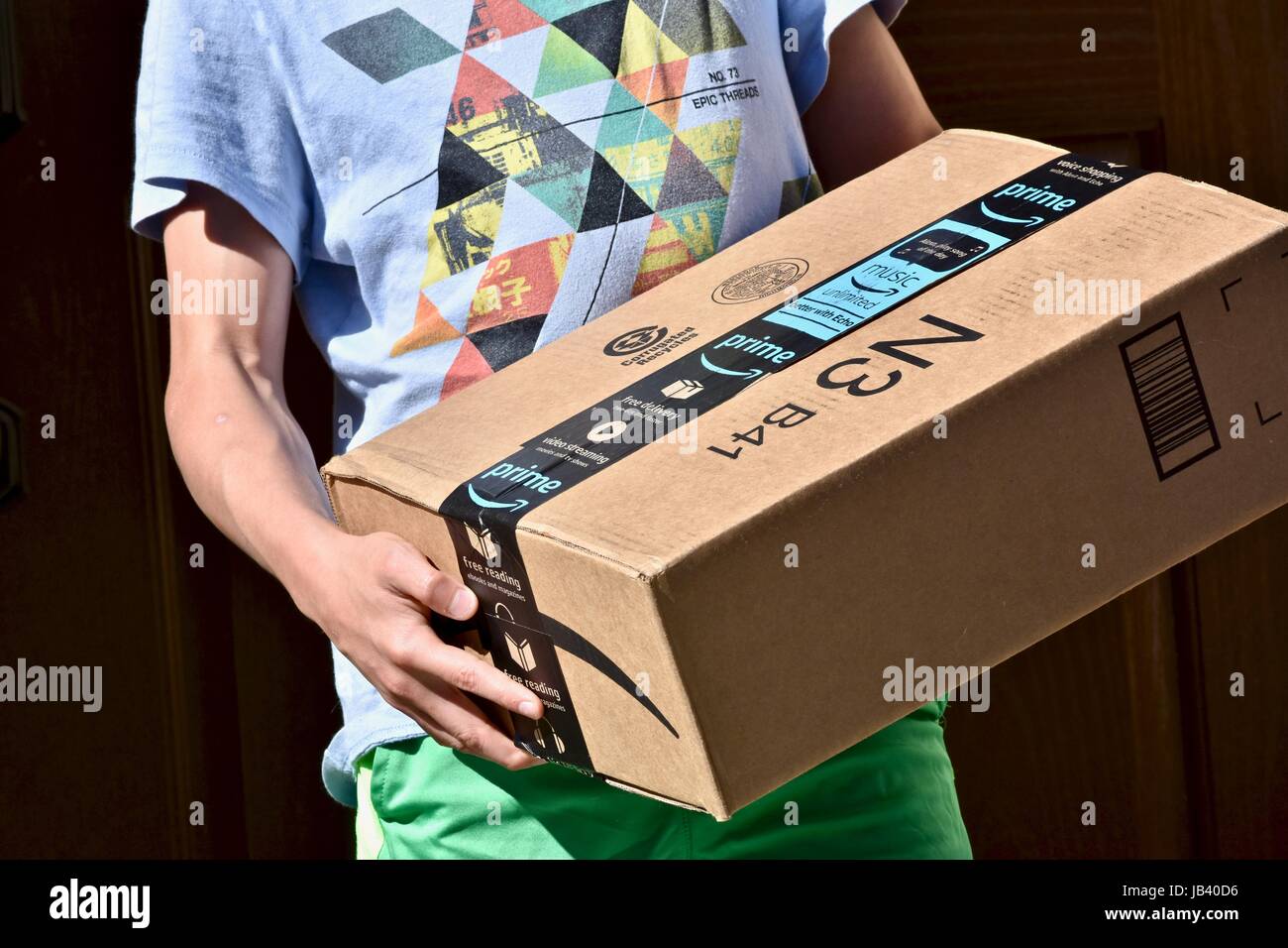 Picking up an Amazon Prime package box that was delivered to the front