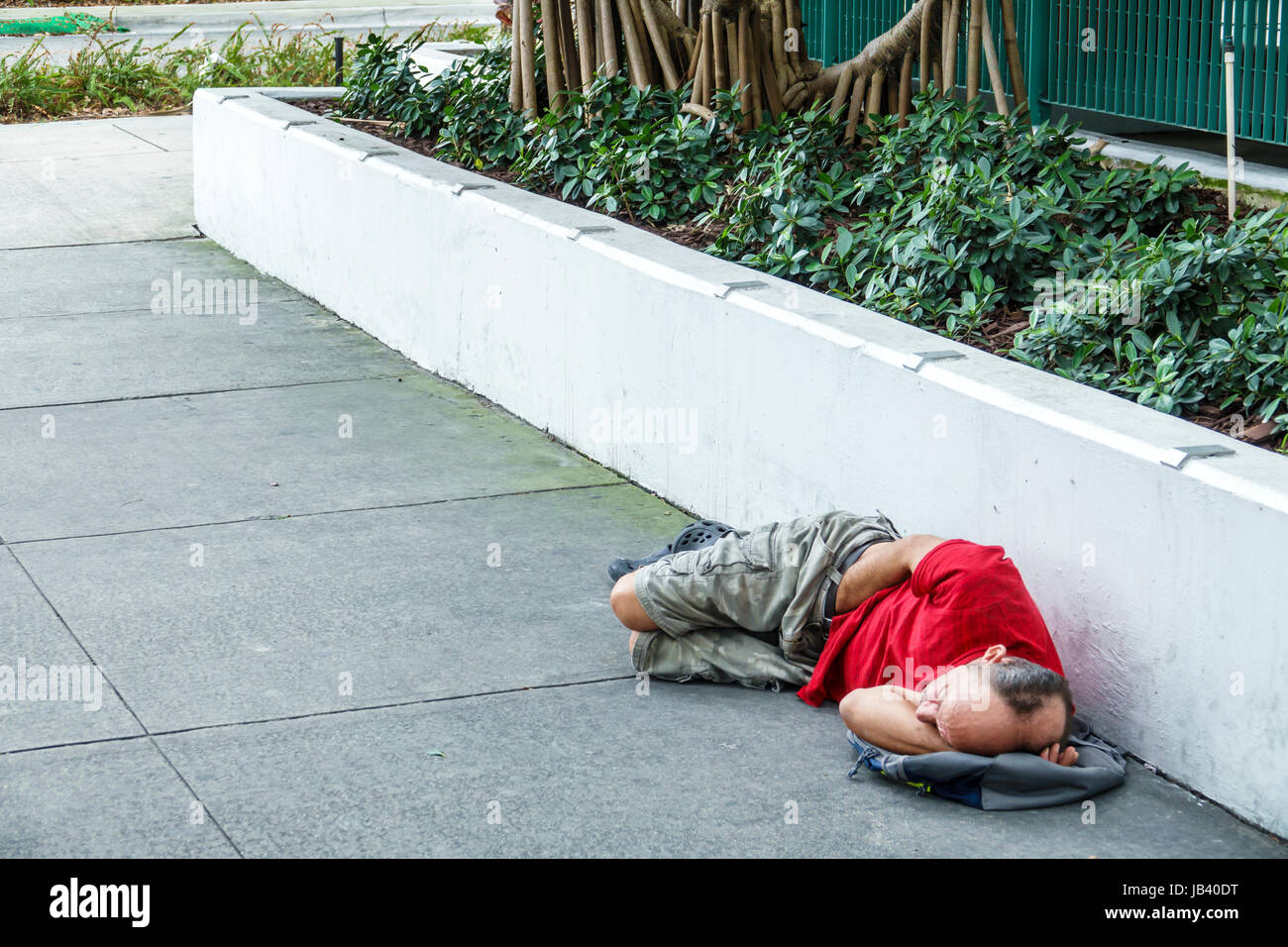 Miami Beach Florida,sidewalk,man men male,homeless,sleeping on ground,sidewalk,FL170401070 Stock Photo