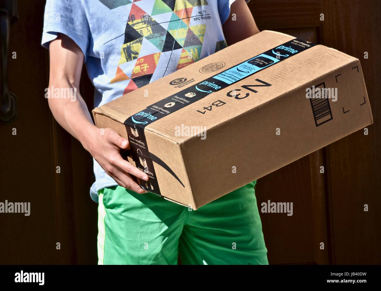 Picking up an Amazon Prime package box that was delivered to the front