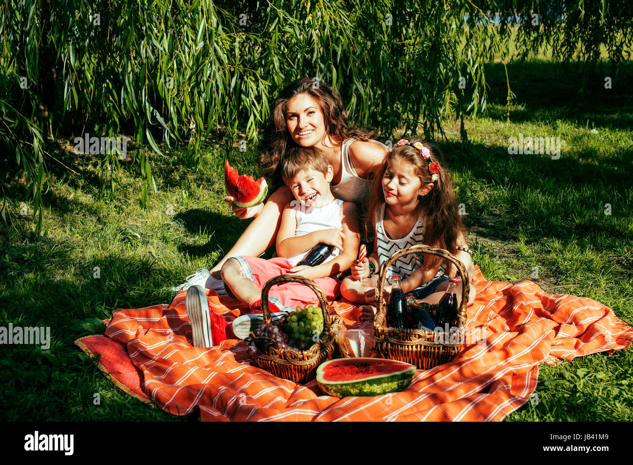 cute happy family on picnic laying on green grass mother and kid Stock ...