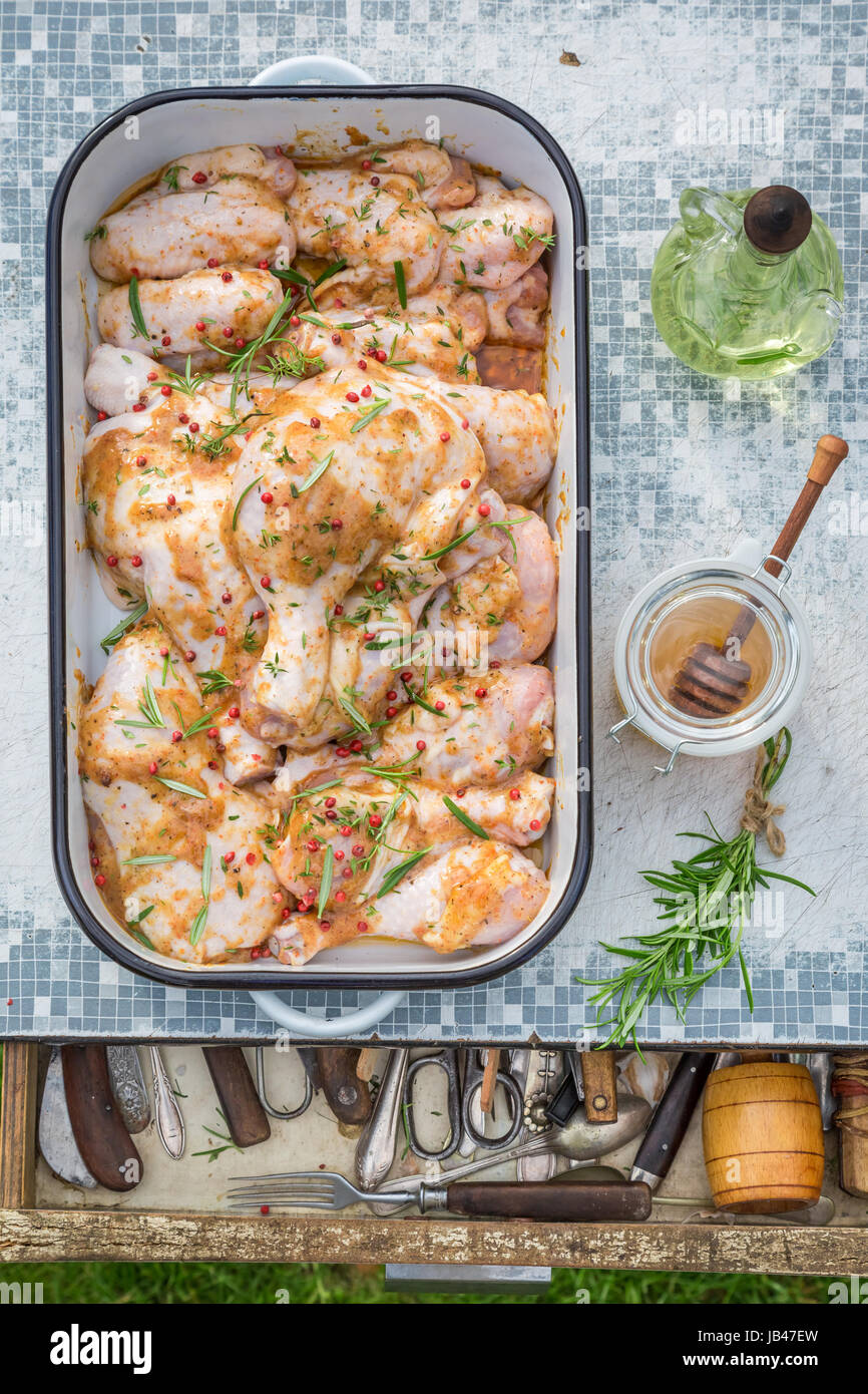 Seasoning fresh chicken legs with herbs for grill Stock Photo Alamy