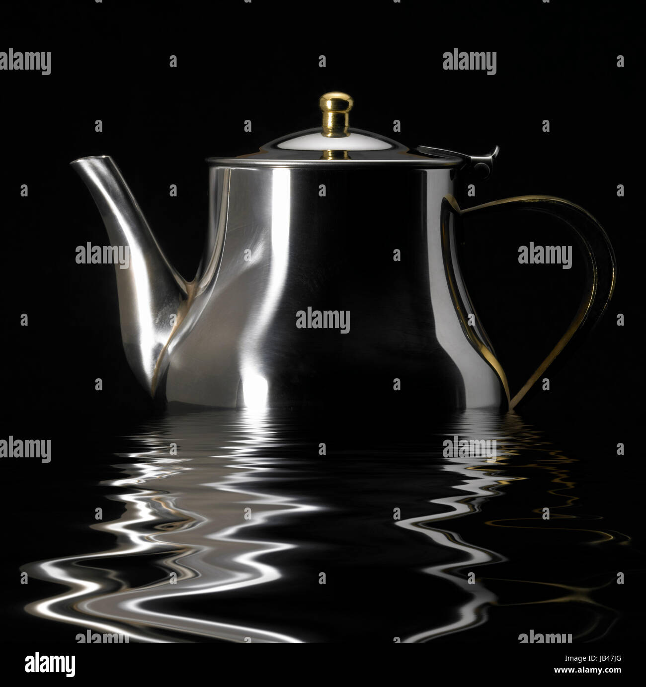 sinking metallic tea pot on reflective water surface in black back ...