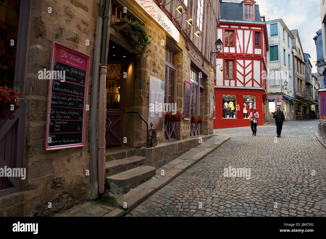 people couple walking on a cobblestone street  past buildings dating to the middle ages, Vannes, France Stock Photo