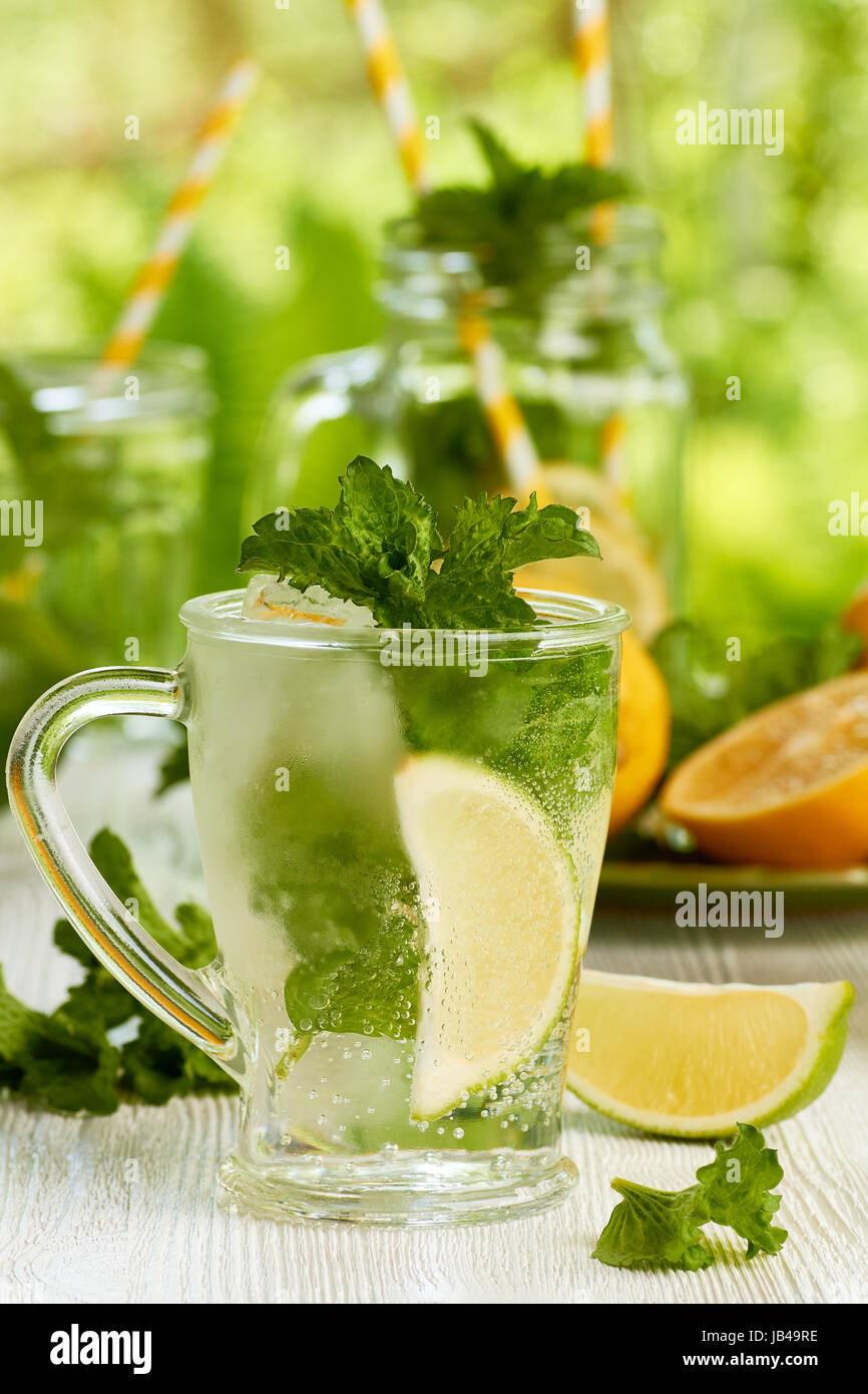 Mojito and Lemonade summer cold drink in a plastic glass with a straw.  Coctail with mint, lemon, lime and ice. Serve at the bar. Beverage closeup  Stock Photo - Alamy