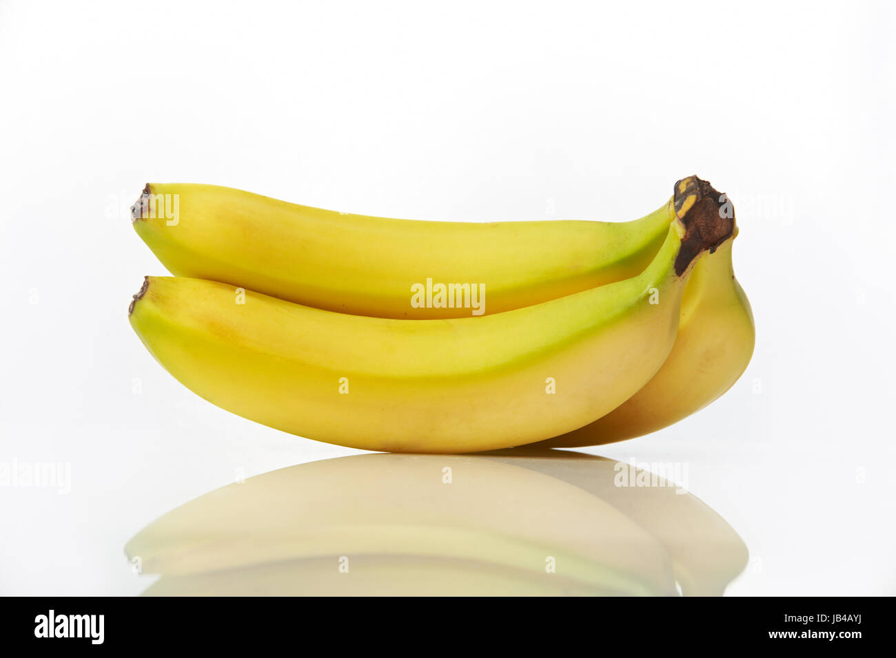 Studio shot of bunch of bananas on white background with reflection ...