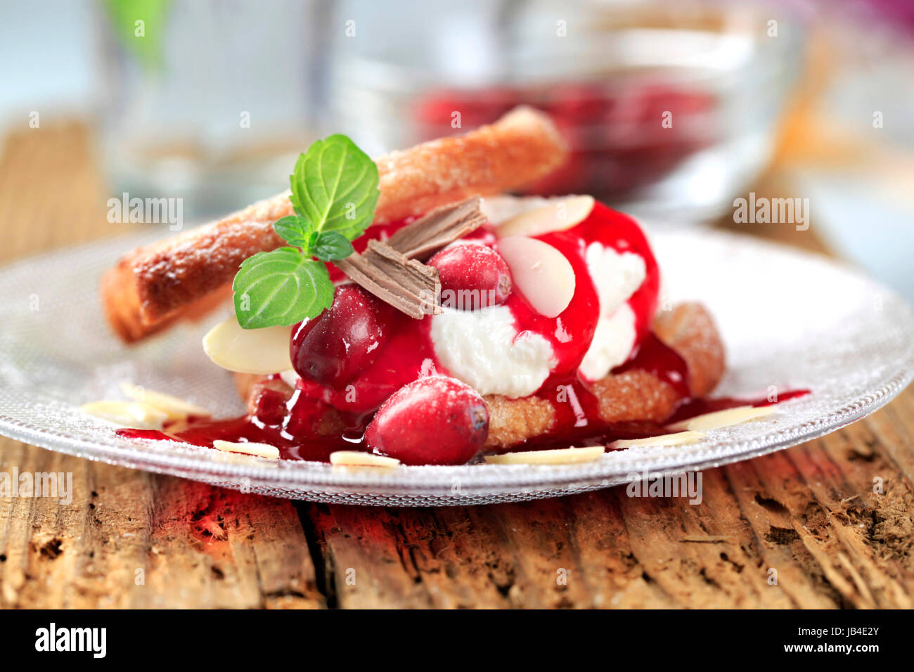 Fan-shaped puff pastries with cream, cranberries and syrup Stock Photo ...