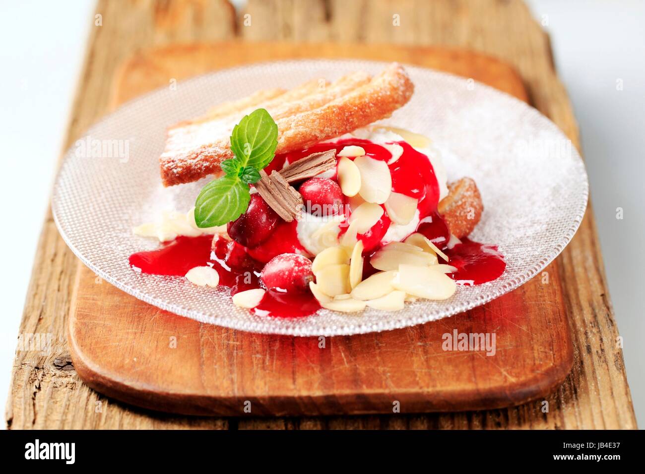 Fan-shaped puff pastries with cream, cranberries and syrup Stock Photo ...