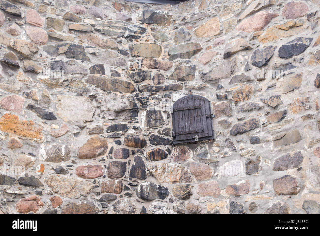 Old field stone wall background with wooden door in the center Stock ...