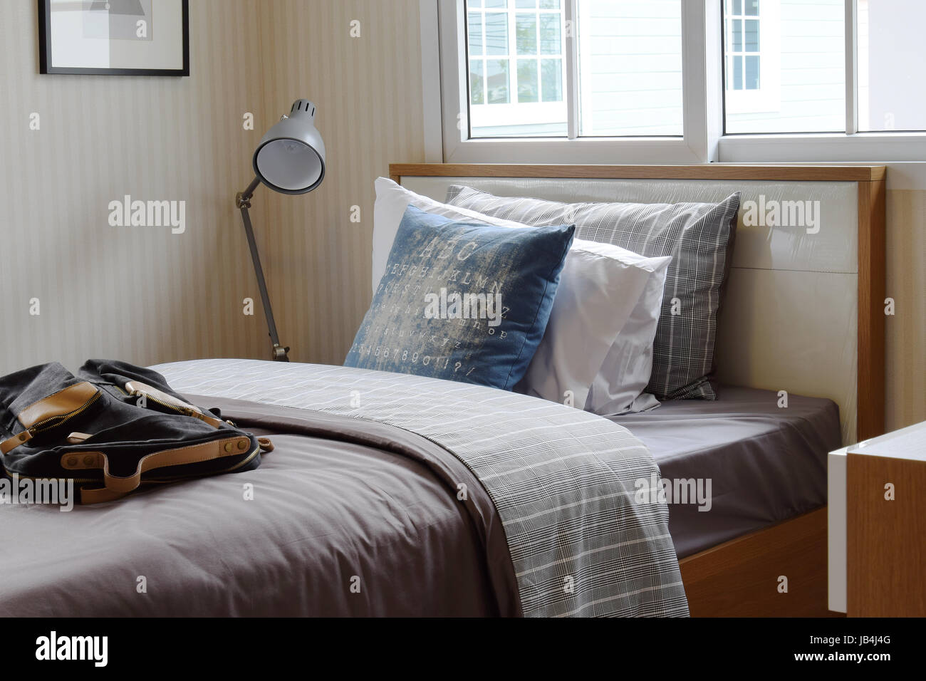 Cozy Bedroom Interior With Pillows And Reading Lamp On