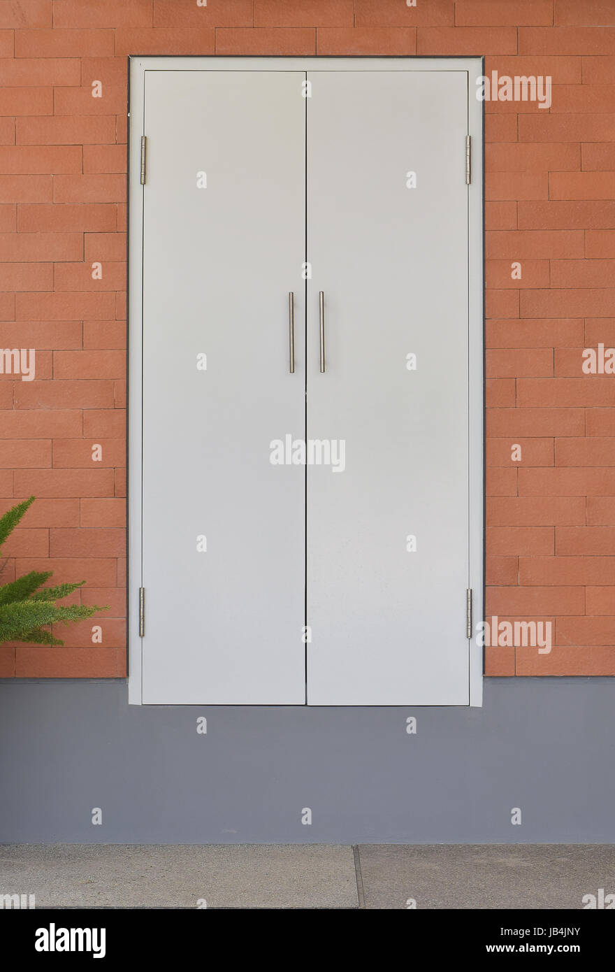 modern white door on brick wall background Stock Photo - Alamy