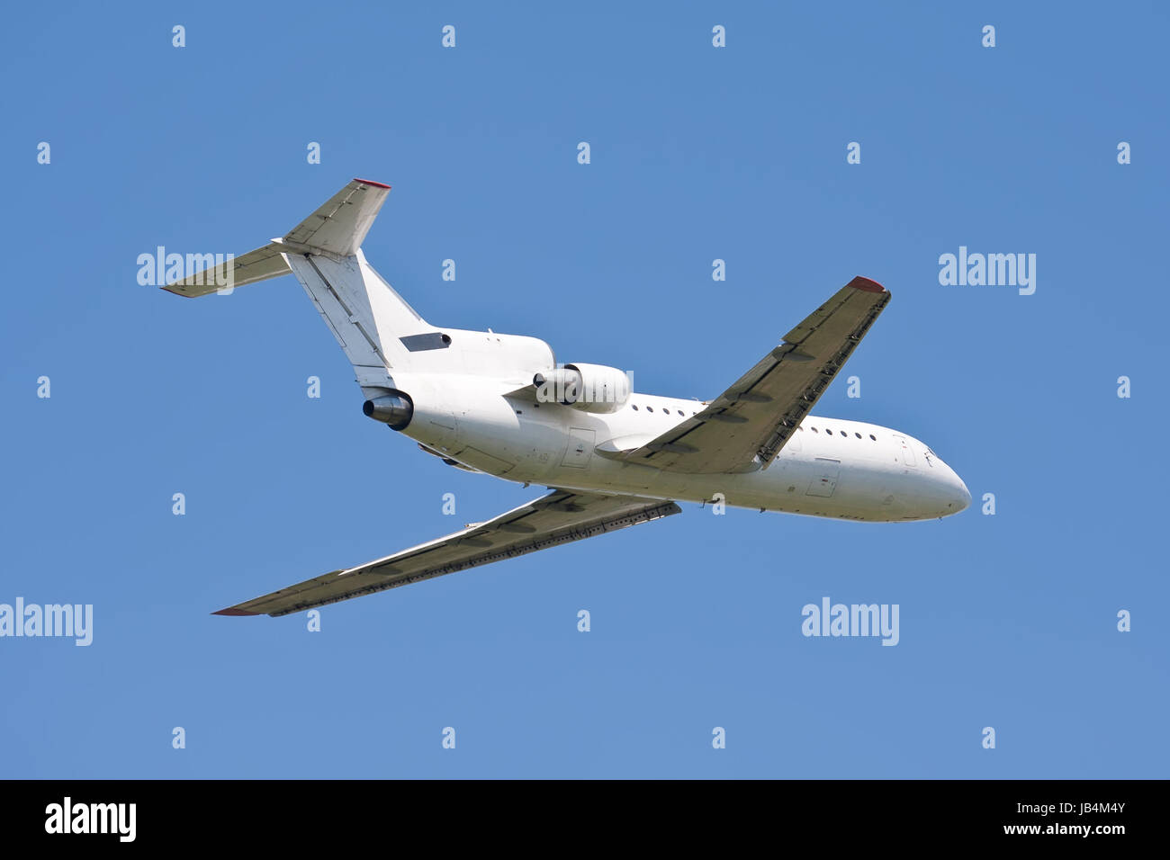 Beautiful white passenger airplane in blue sky Stock Photo - Alamy