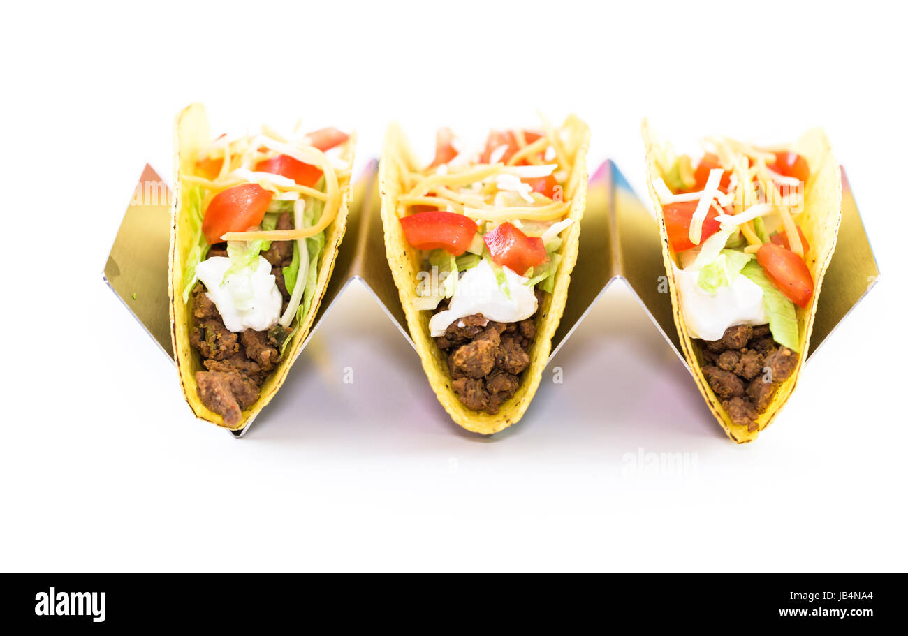 Fresh beef tacos in hard yellow corn taco shell with sour cream and ...