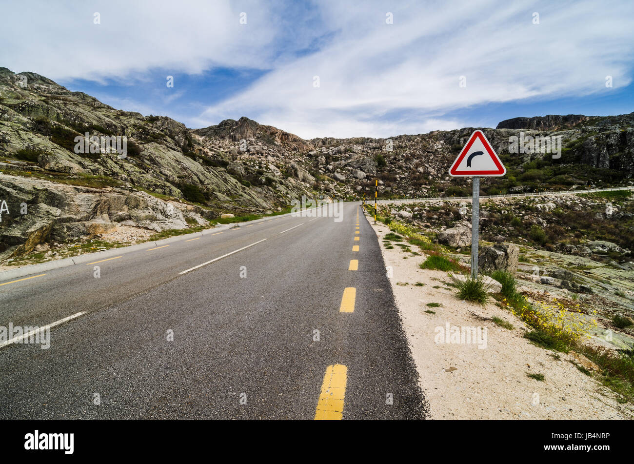 Asphalt road in the mountains and blue sky with clouds Stock Photo - Alamy