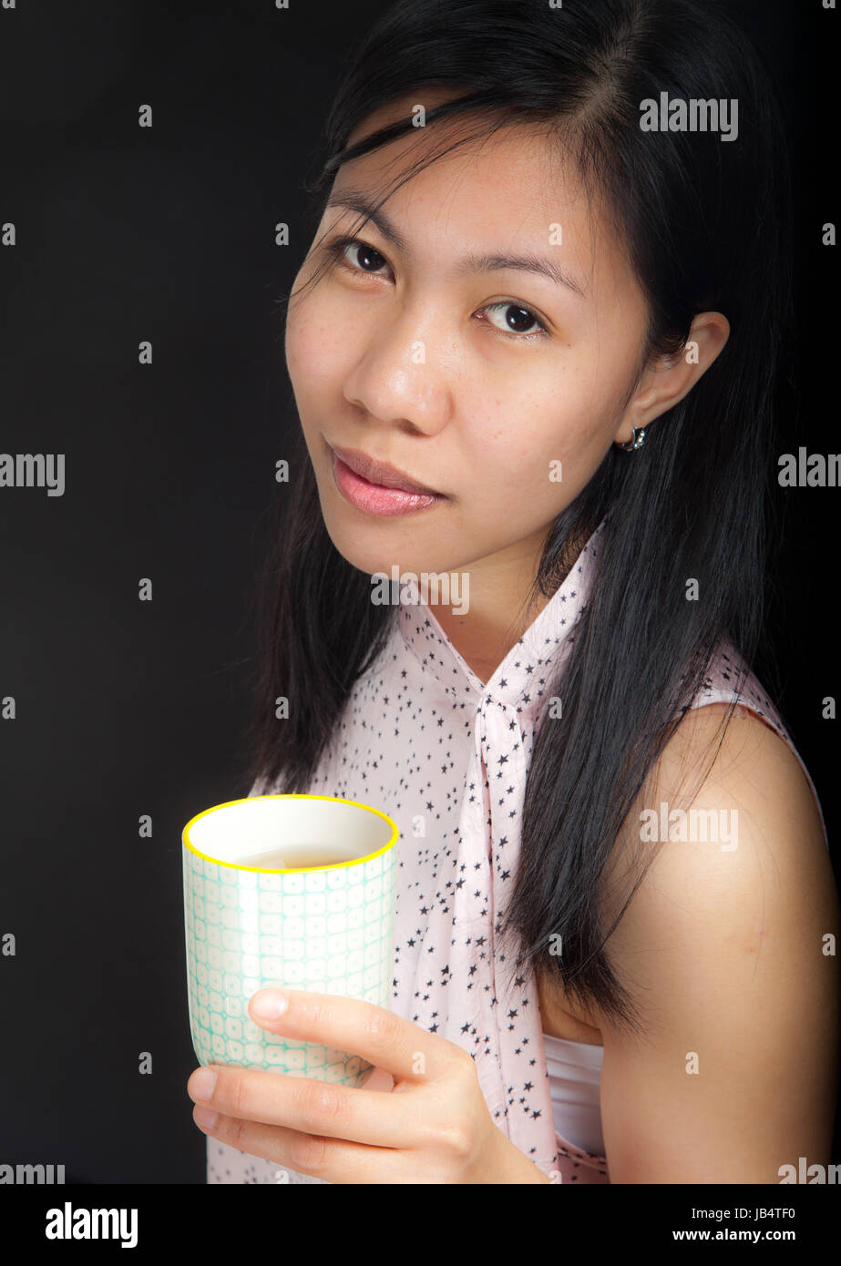 Portrait Of A Cute Young Asian Girl In Studio Looking At The Camera Stock Photo Alamy