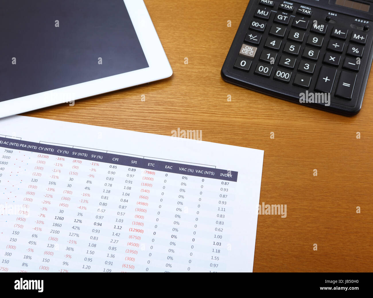 Office table with tablet, calculator and data chart Stock Photo Alamy