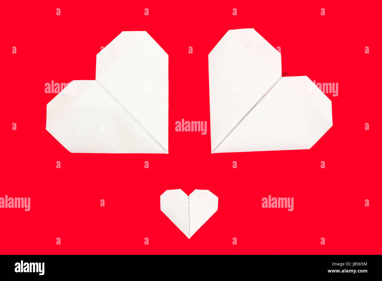 Origami paper heart shapes on red background for valentines day Stock ...