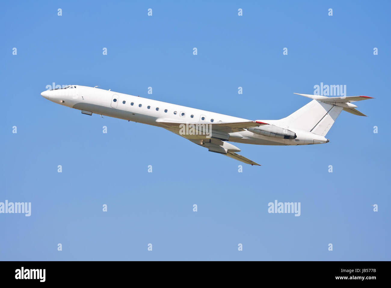 Beautiful white passenger airplane in blue sky Stock Photo - Alamy