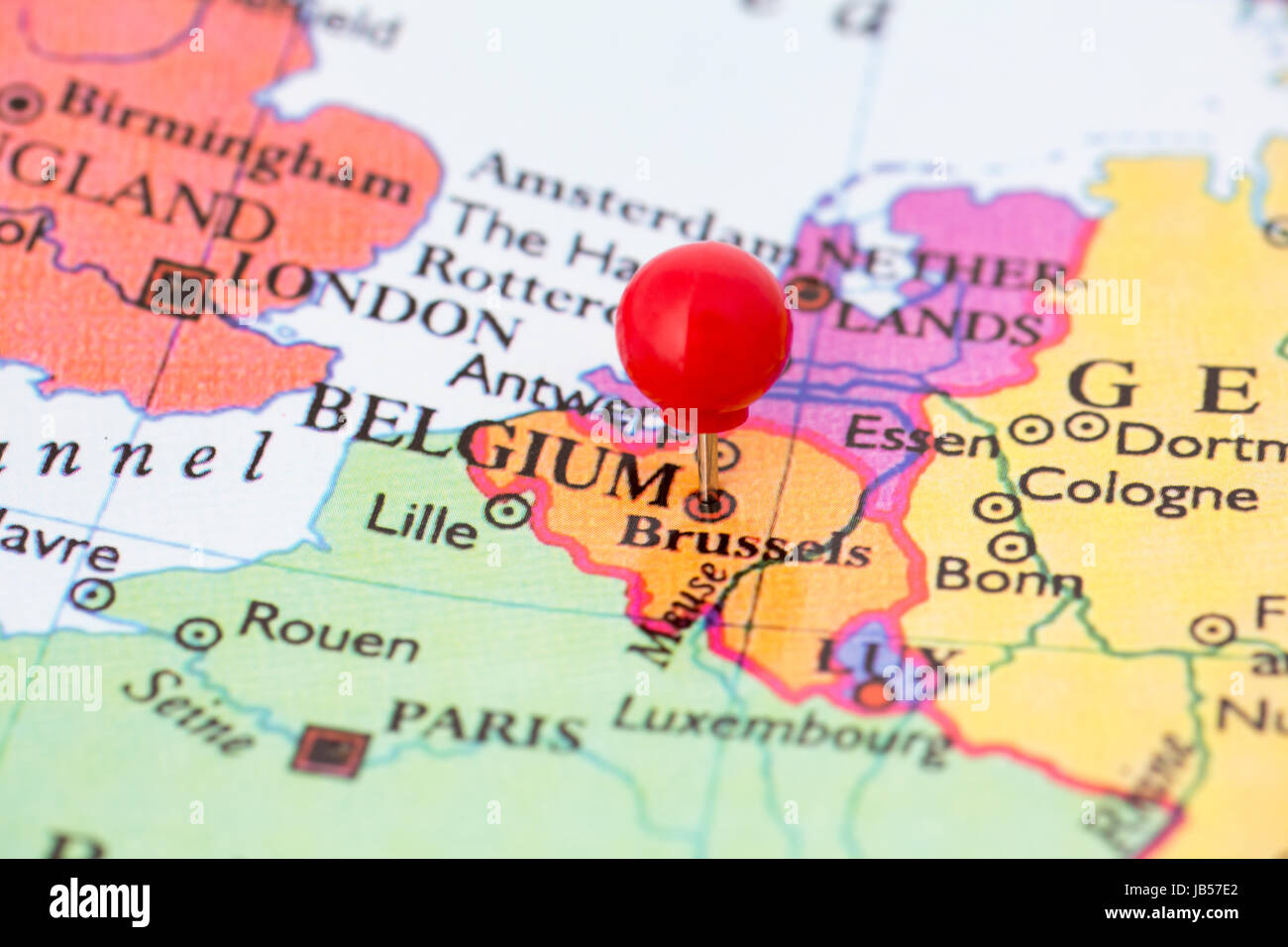 Round red thumb tack pinched through Brussels on Belgium map. Part of collection covering all major capitals of Europe. Stock Photo
