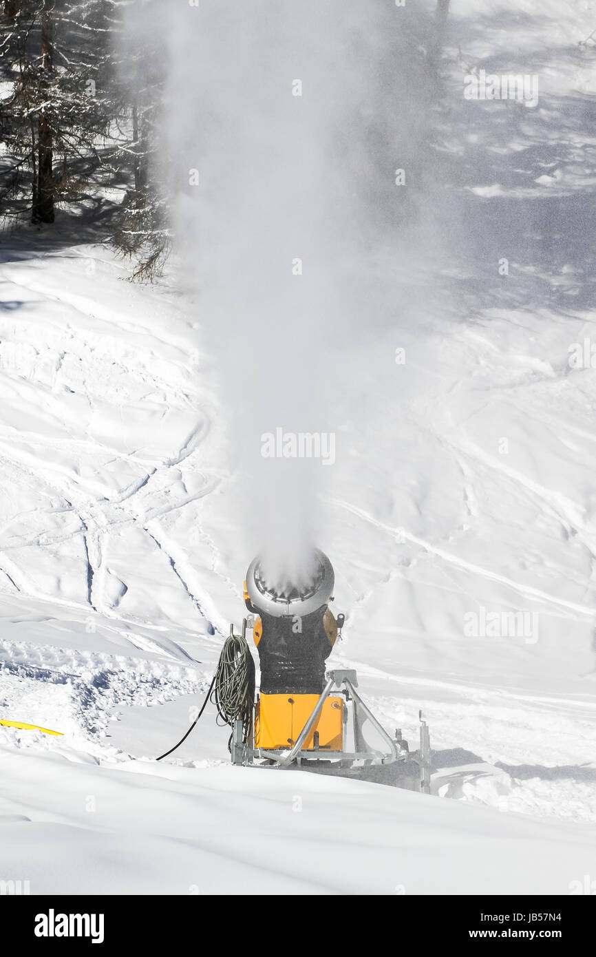 Snow cannon gun, artificial snow making machine on the slopes of a ski  resort, ski lift and piste Stock Photo - Alamy