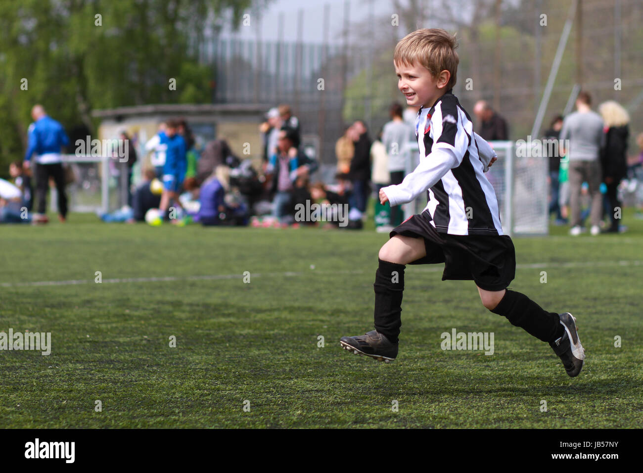 Boy running on soccer field. Trademarks have been removed Stock Photo