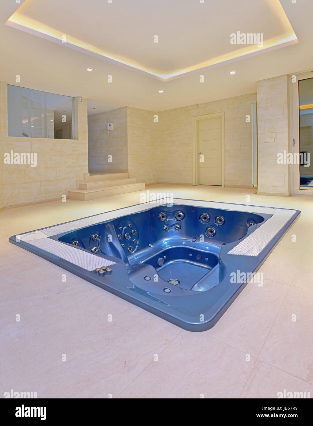 Big empty hot tub built into floor interior room Stock Photo Alamy