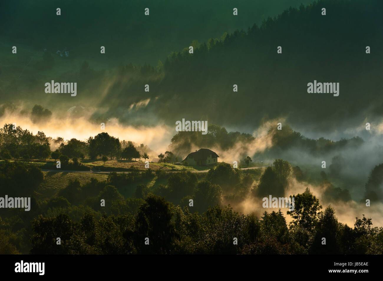 Morning in mountains with fog and clouds during sunrise Stock Photo - Alamy