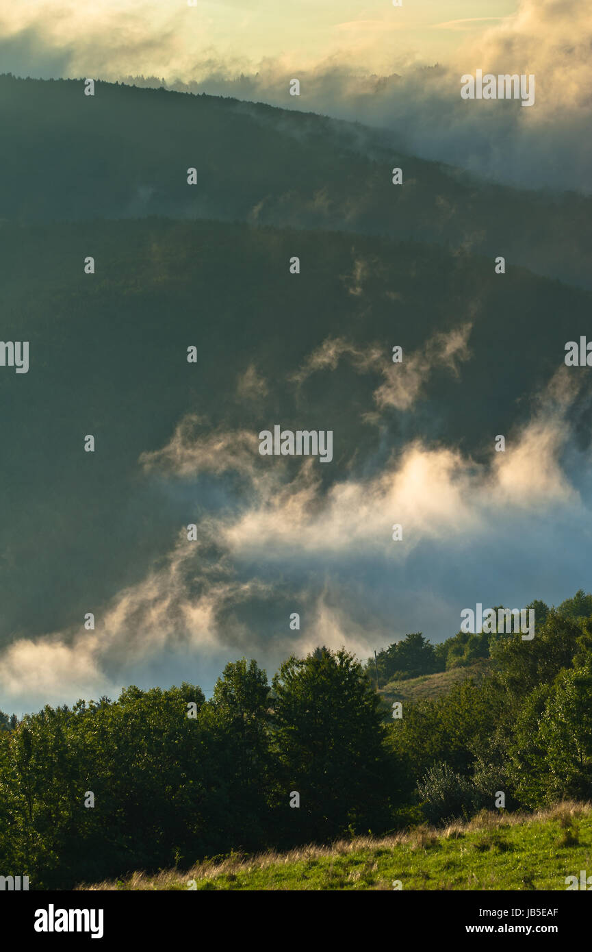 Morning in mountains with fog and clouds during sunrise Stock Photo - Alamy