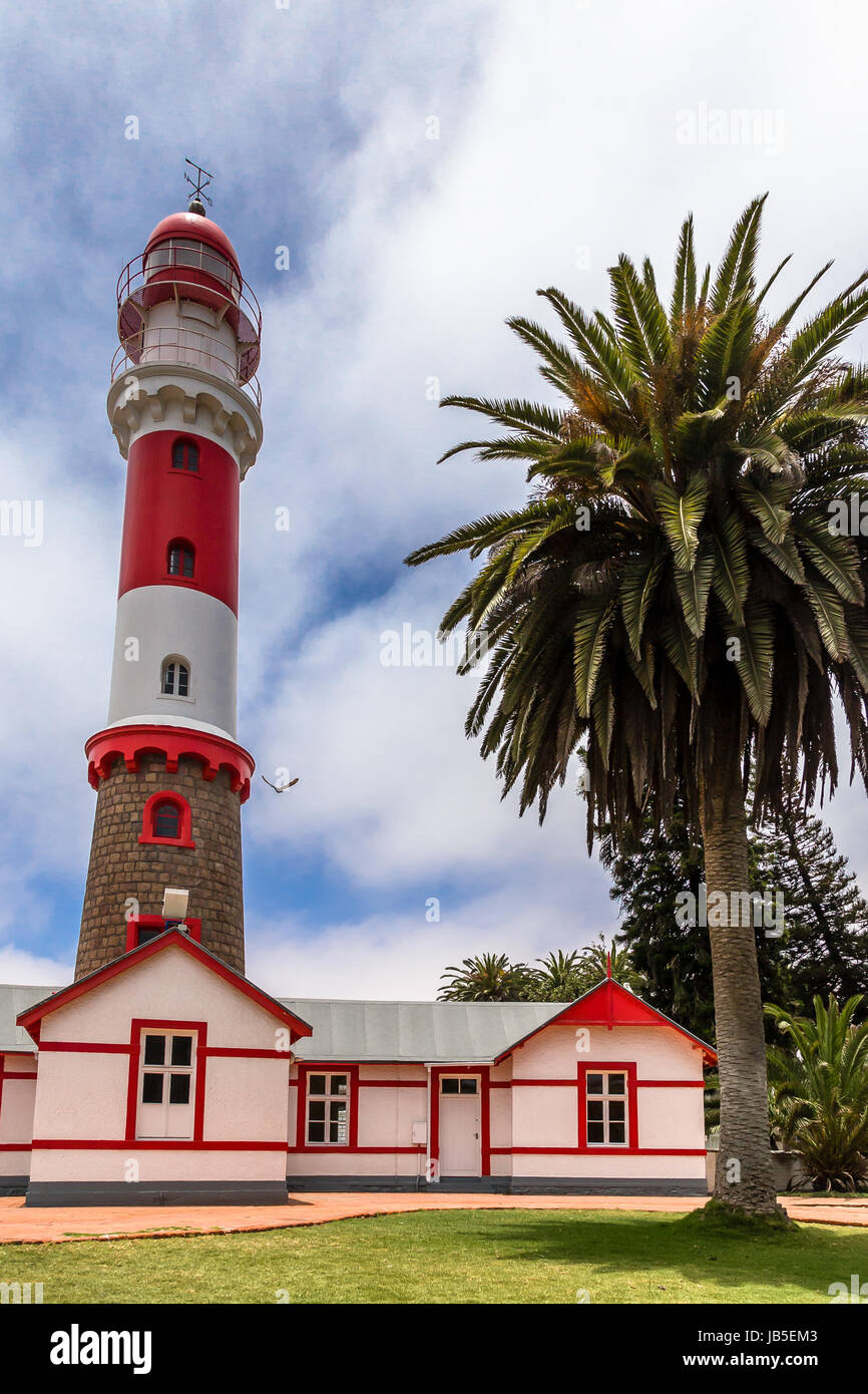 Red white lighthouse, and palm tree, Swakopmund, German  colonial town, Namibia Stock Photo