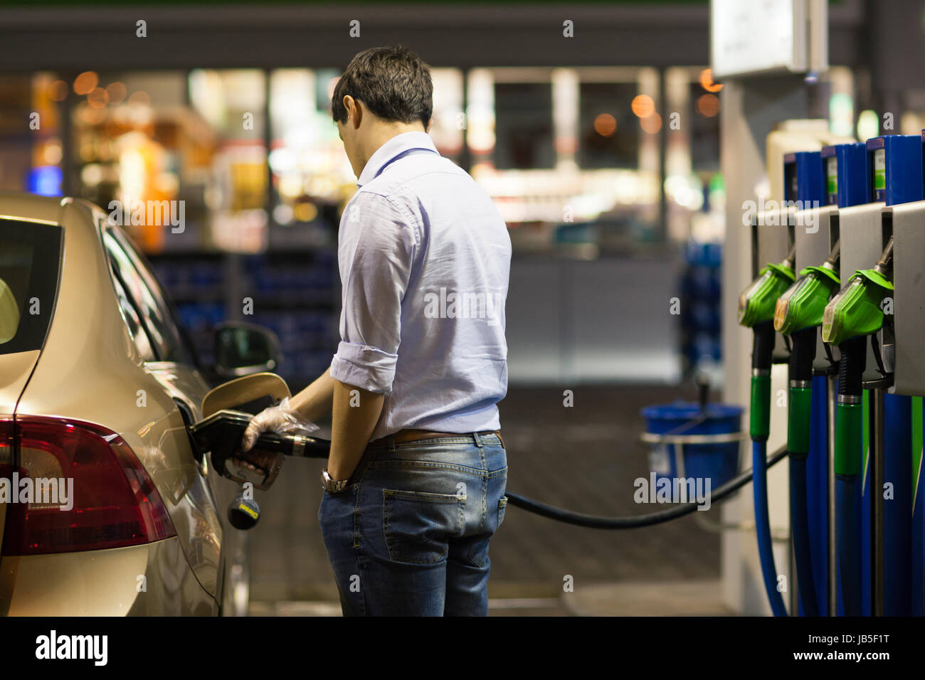 Young man fueling his car at the gas station Stock Photo Alamy