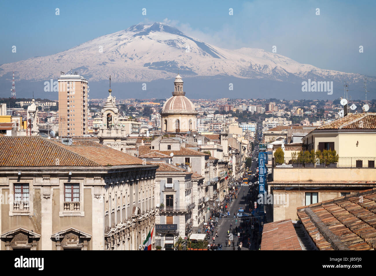 Catania, the central 'Via Etnea' street with the snow covered Mount Etna volcano, Sicily, Italy. Stock Photo