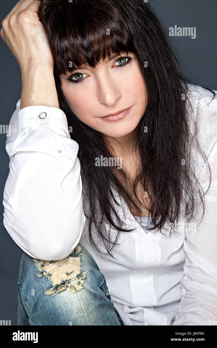 Front view of attractive brunette woman looking into the camera Stock Photo