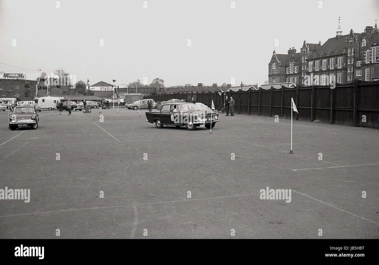 1960s, historical, picture shows cars negotiating around flagposts in the car park at the Catford Greyhound Stadium, Lewisham, London, SE6, in the Learner Driver of the Year contest. Stock Photo