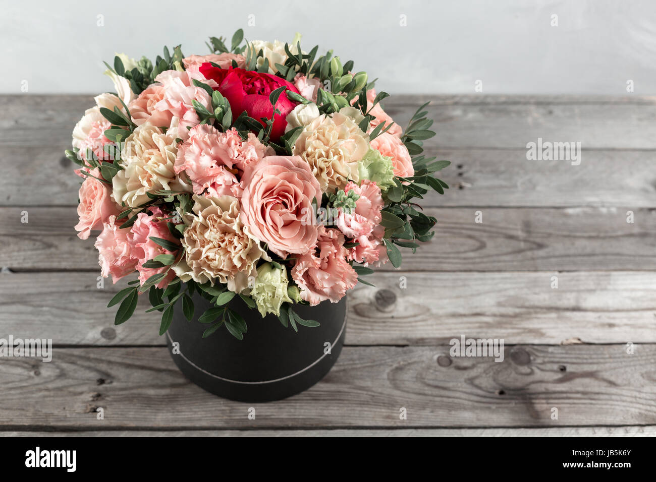 luxurious and elegant bouquet of roses and Other colors flowers on wooden background, copy space. Stock Photo