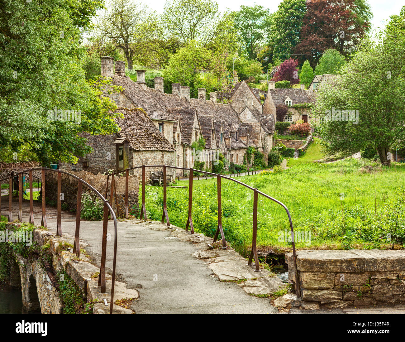 Old footbridge and  traditional Cotswold cottages,   Bibury,  England, UK. Stock Photo