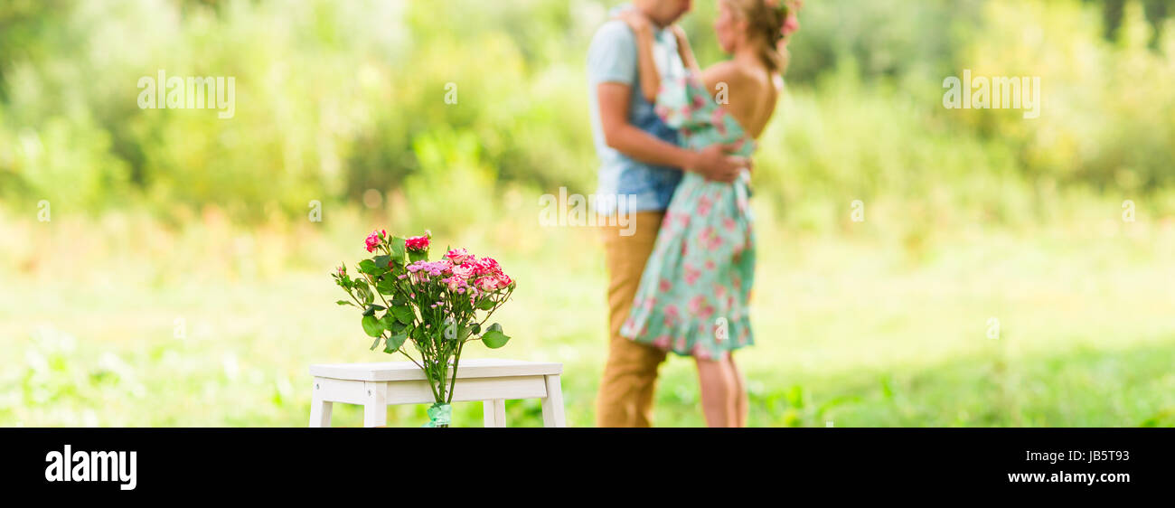 Happy Romantic couple hugging. Focus on flowers. selective focuse. Stock Photo