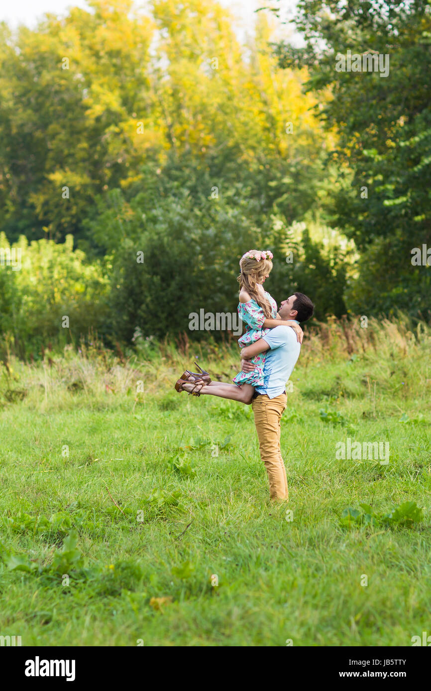 A couple in love beautiful young men hugging in a summer park on a ...