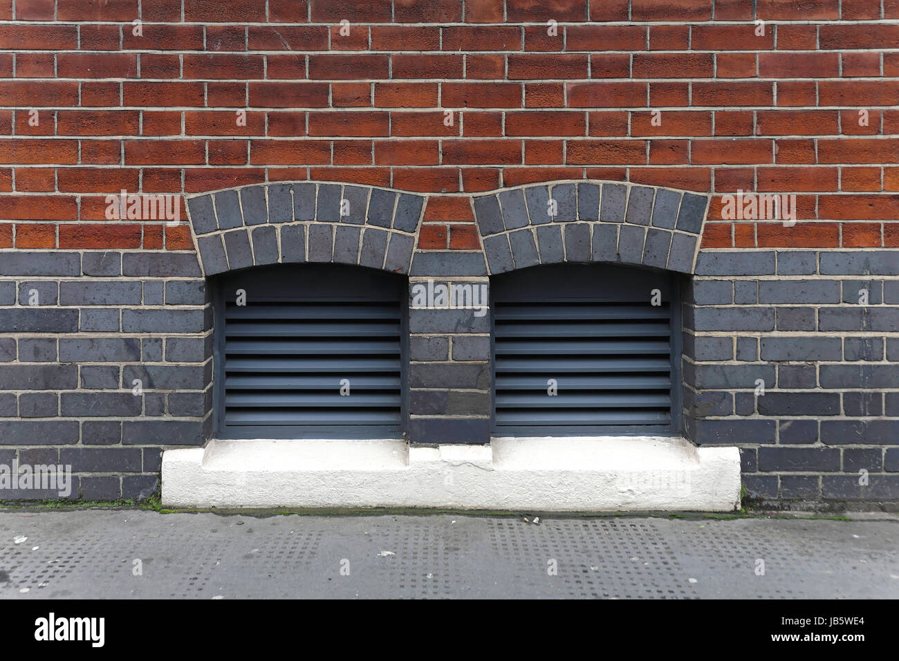 Two ventilation inlets at brick building exterior Stock Photo - Alamy
