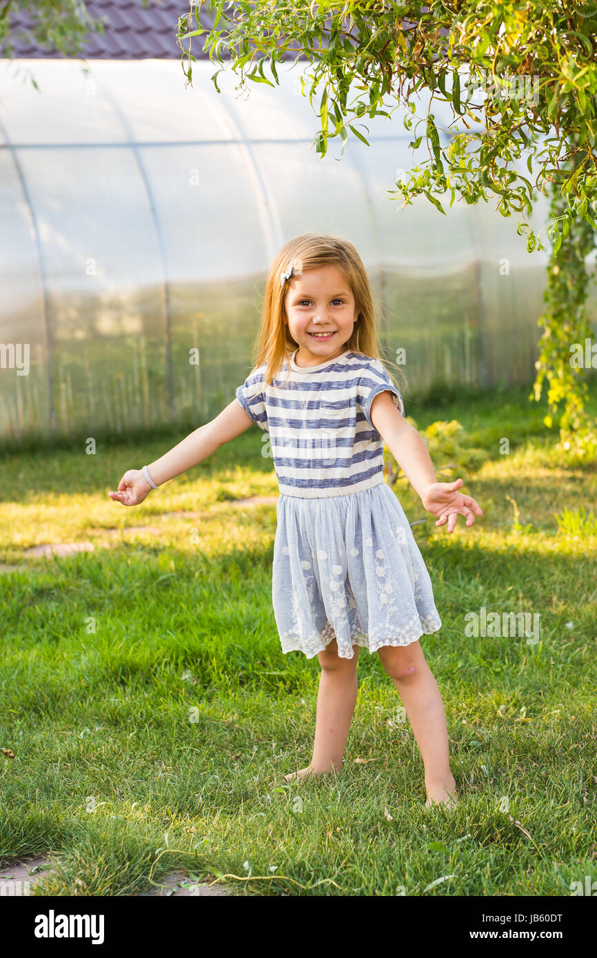 Cute little girl is playing in summer park Stock Photo - Alamy