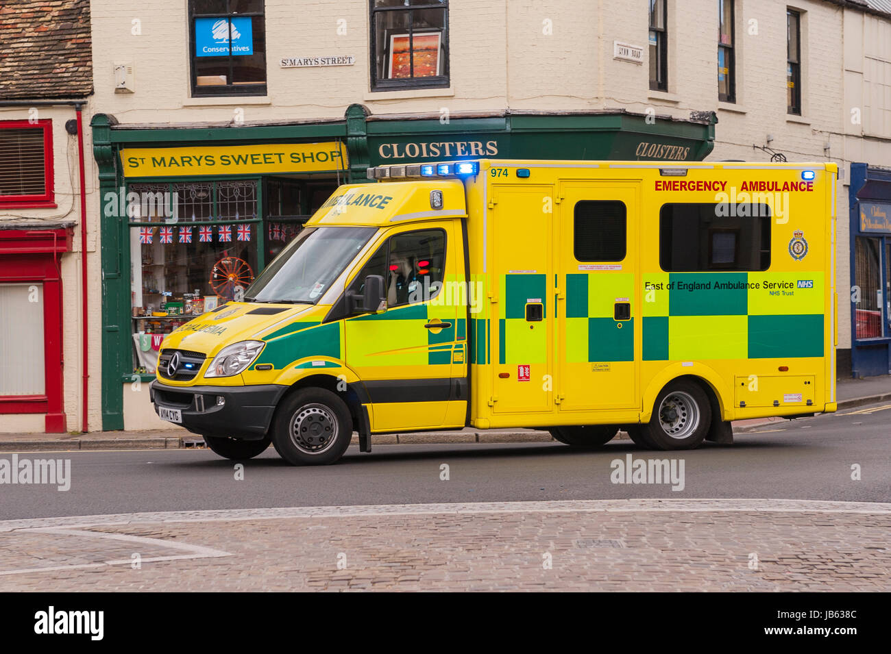 An Ambulance with blue lights flashing in Ely , Cambridgeshire