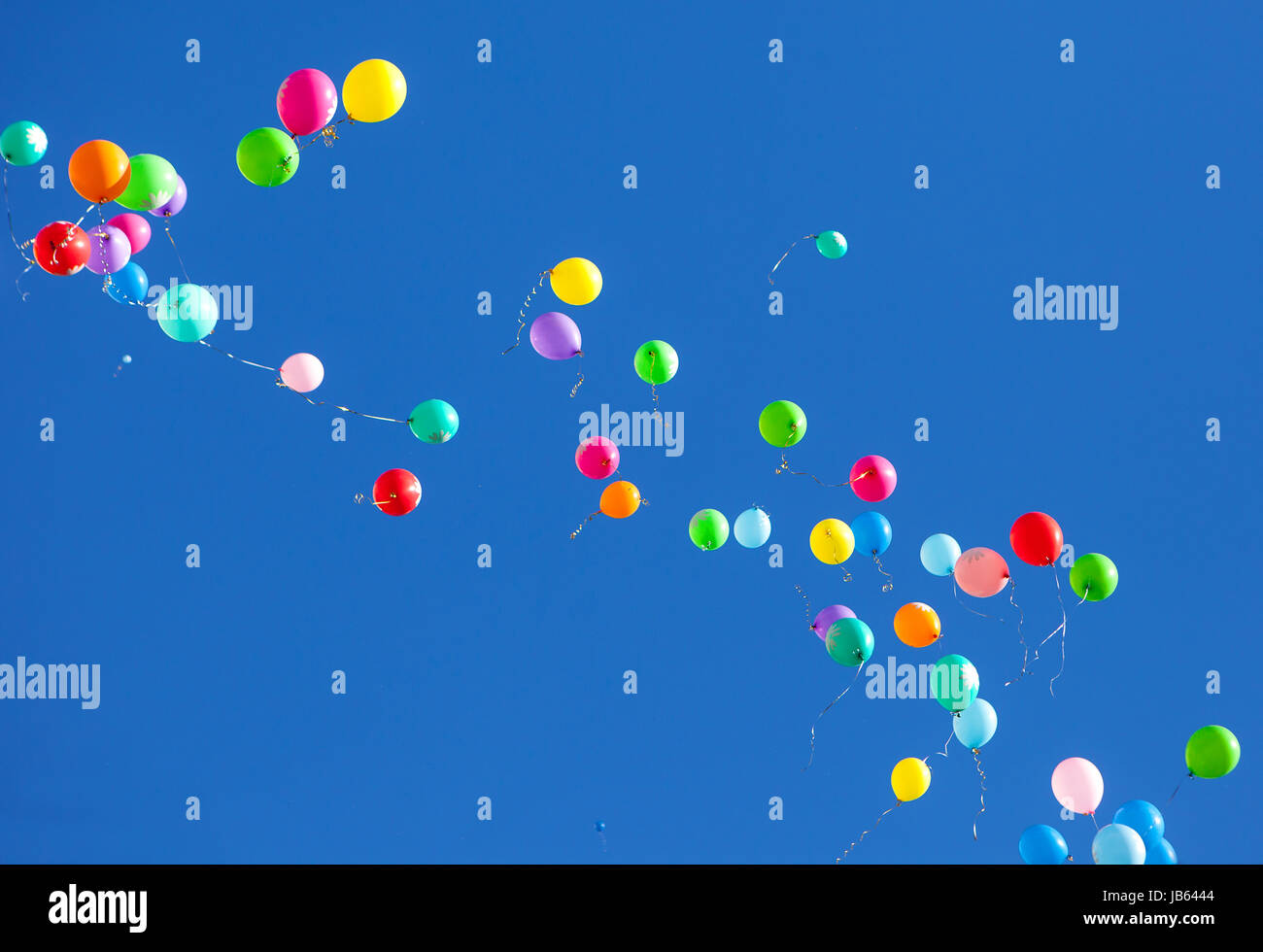 Colorful balloons on a blue sky background Stock Photo - Alamy