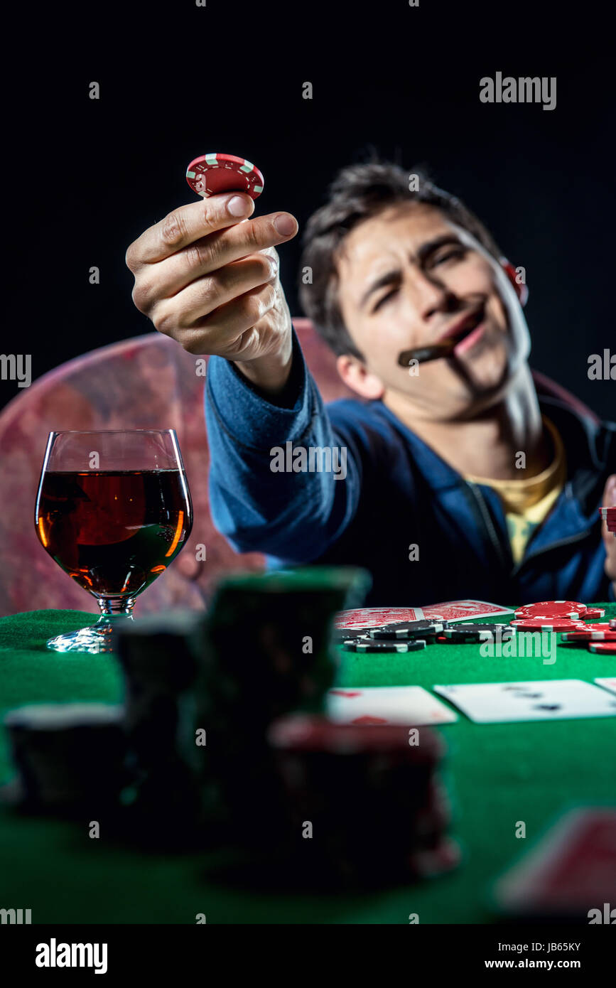 Poker player holding poker chip Stock Photo Alamy