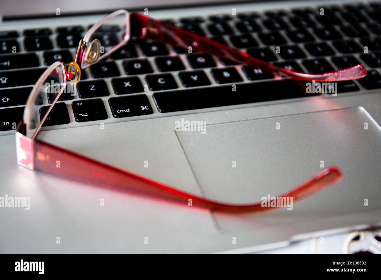Red glasses and notebook computer Stock Photo