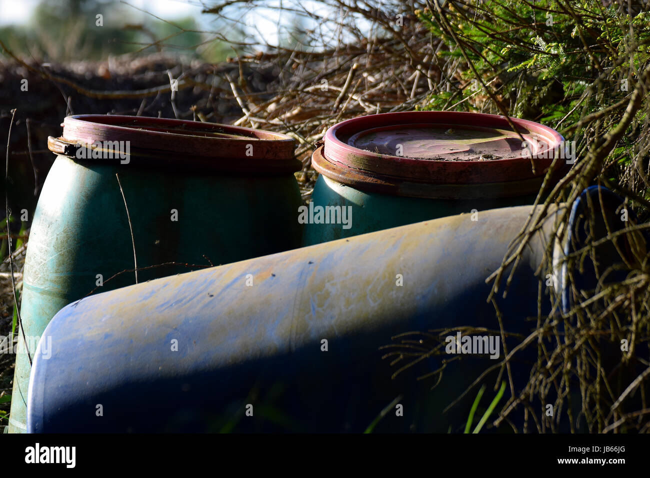 Old plastic barrels left in nature. Horizontal image Stock Photo