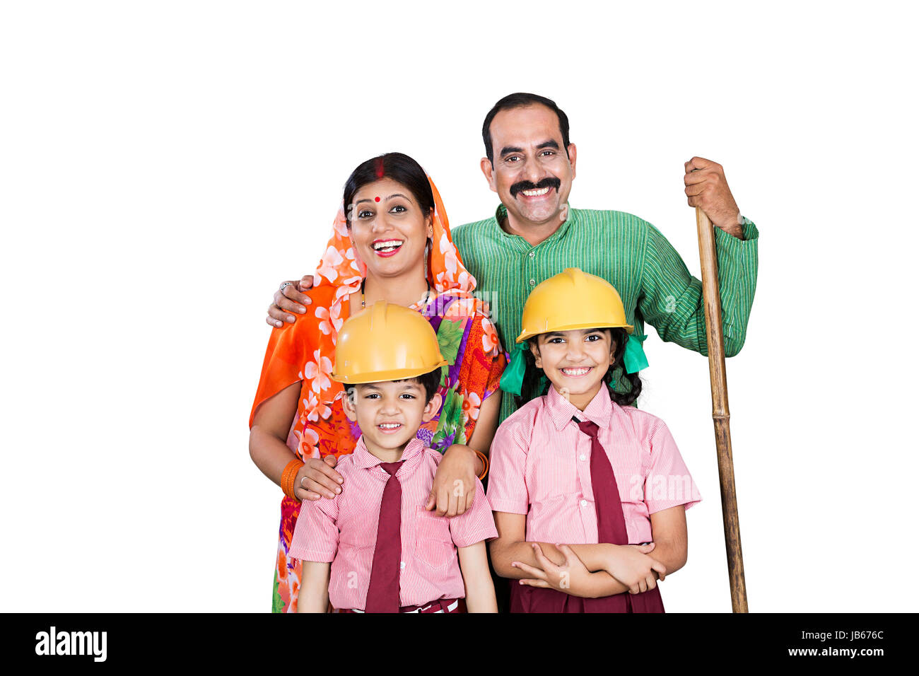Indian Rural Farmer Family- Parents and 2 Kids Standing Together. Kids Students Wearing Helmet Dreaming Architect Stock Photo