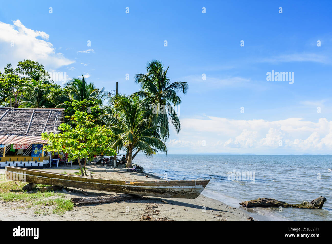 Livingston, Guatemala - August 31, 2016: Boat pulled ashore on beach in Caribbean town of Livingston Stock Photo
