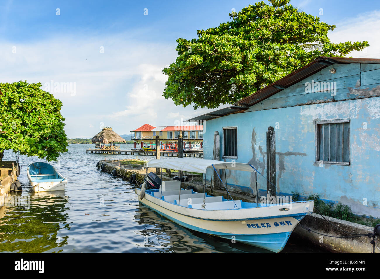 Livingston, Guatemala - August 31, 2016: Boats moored along commercial area of riverbank on estuary of Rio Dulce in Caribbean town of Livingston Stock Photo