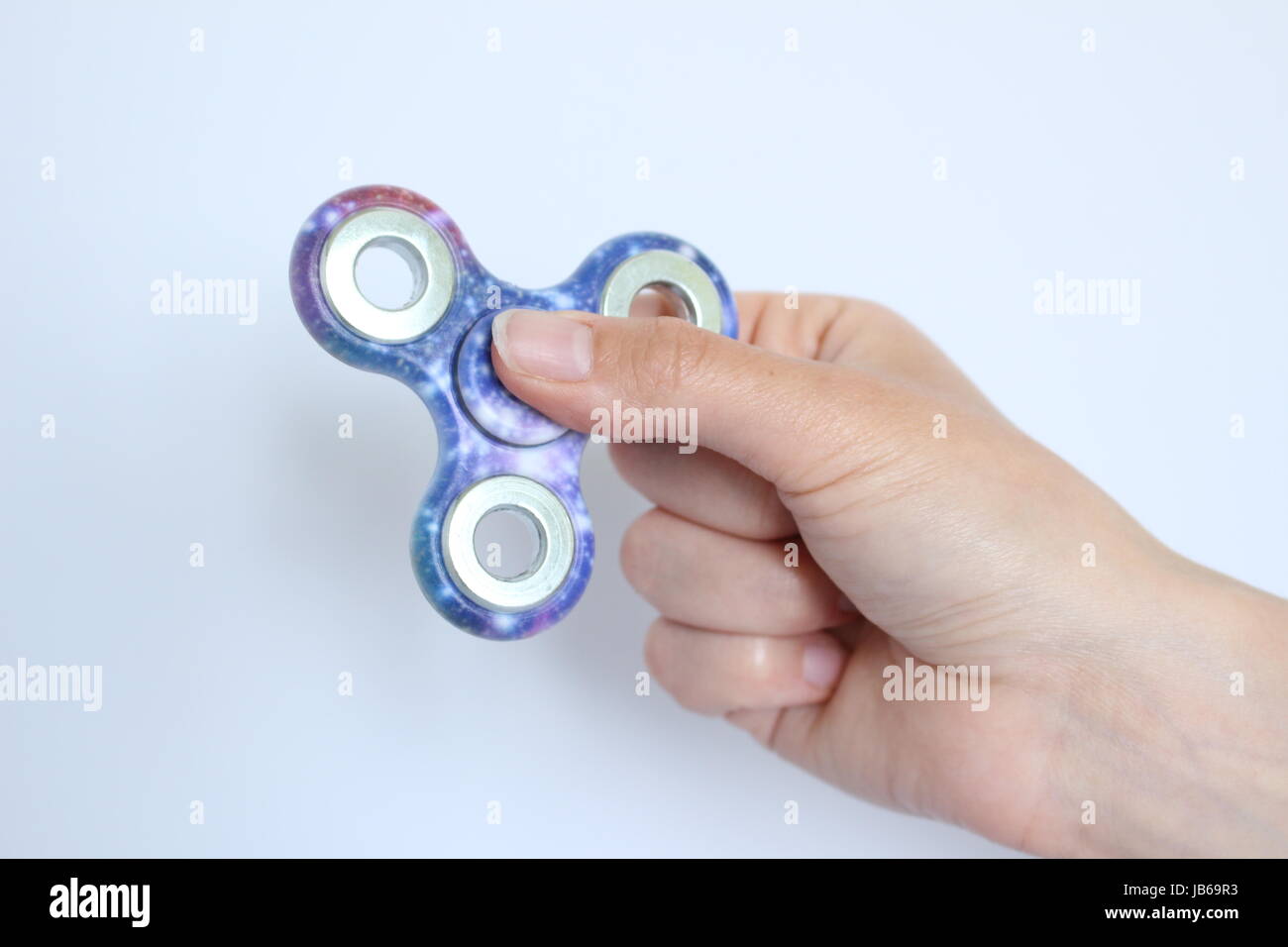 Toy stress Fidget spinner hand for child and adult colorful Stock Photo